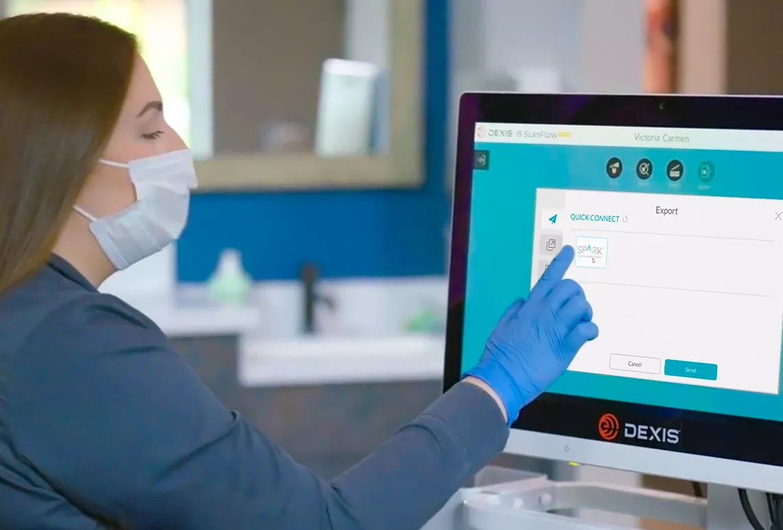 Spark doctor pointing to Dexis software on monitor