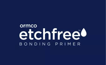 Clear placement guide positioned over teeth with metal brackets in an orthodontic illustration.