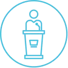 Icon of a person standing behind a podium, symbolizing education, training, or professional development.