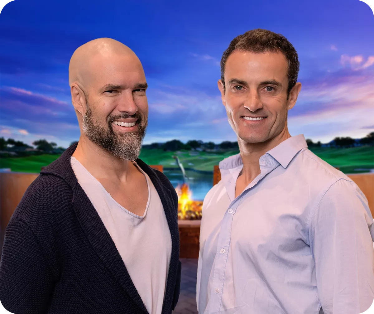 Two people standing together in an event setting with a scenic backdrop.